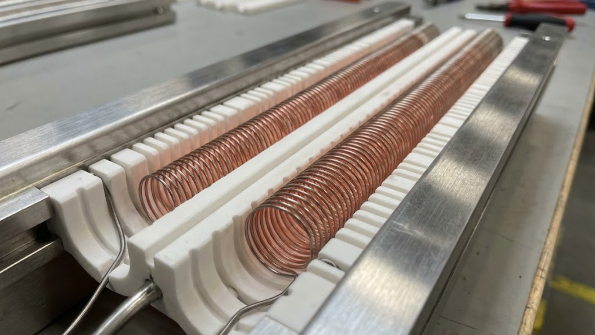 Open coil electric heater elements mounted in ceramic insulation supports